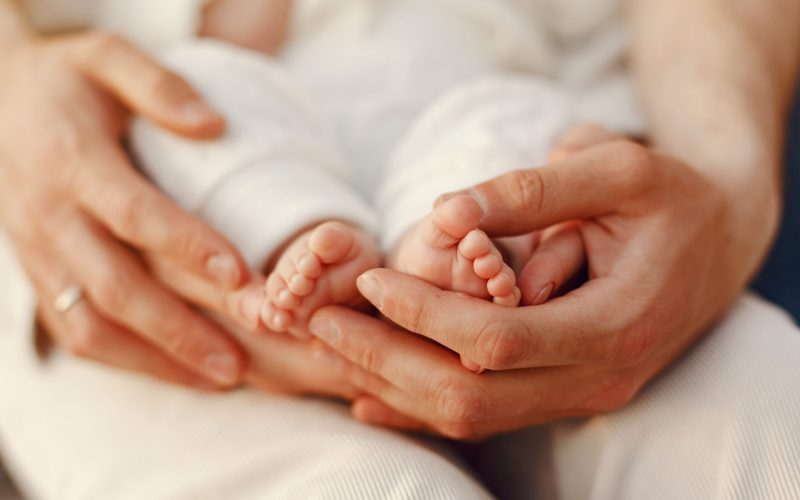 Parents with daughter. Family in a park. Newborn girl.
